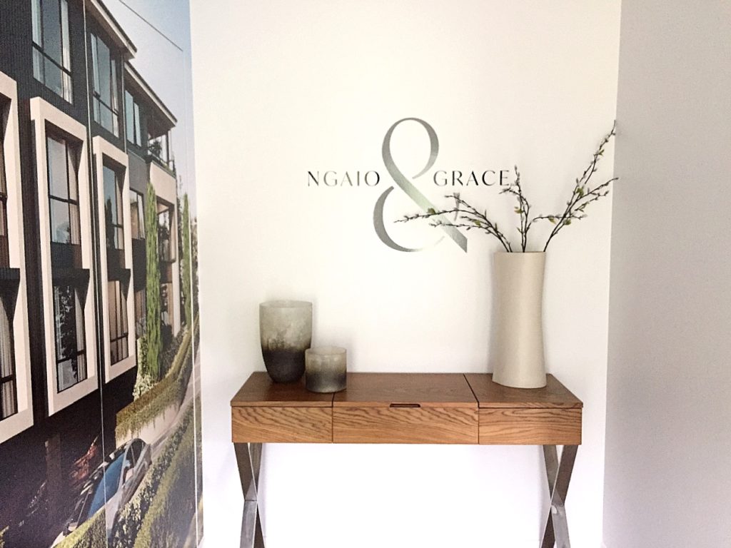 wood hallway console table styled with plant and vases