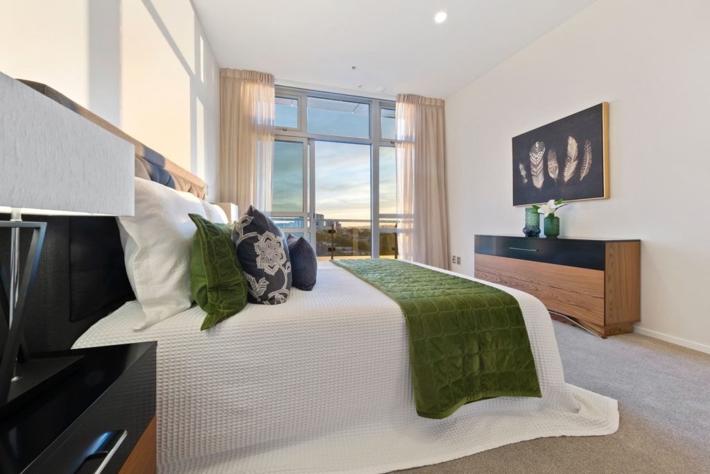 master bedroom with black and green cushions