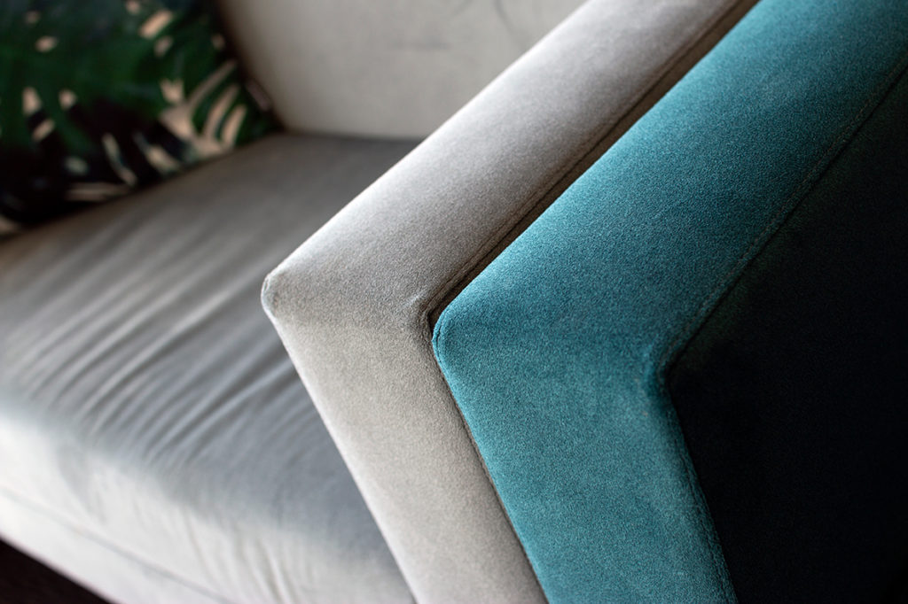 close up of modern armchairs in teal and blue grey fabric