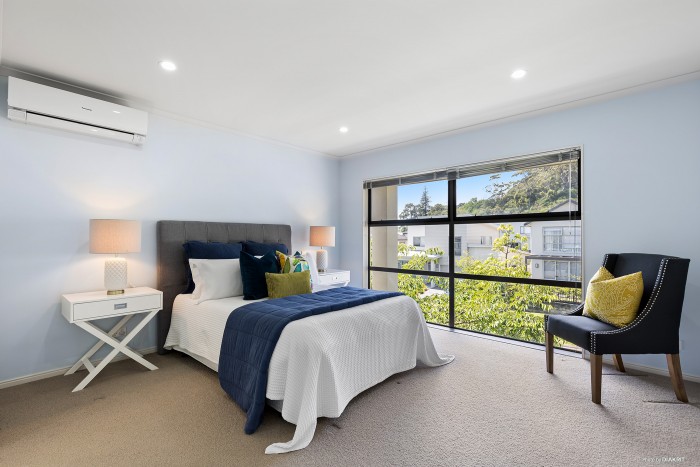 modern bedroom with blue floral bedding and light blue walls