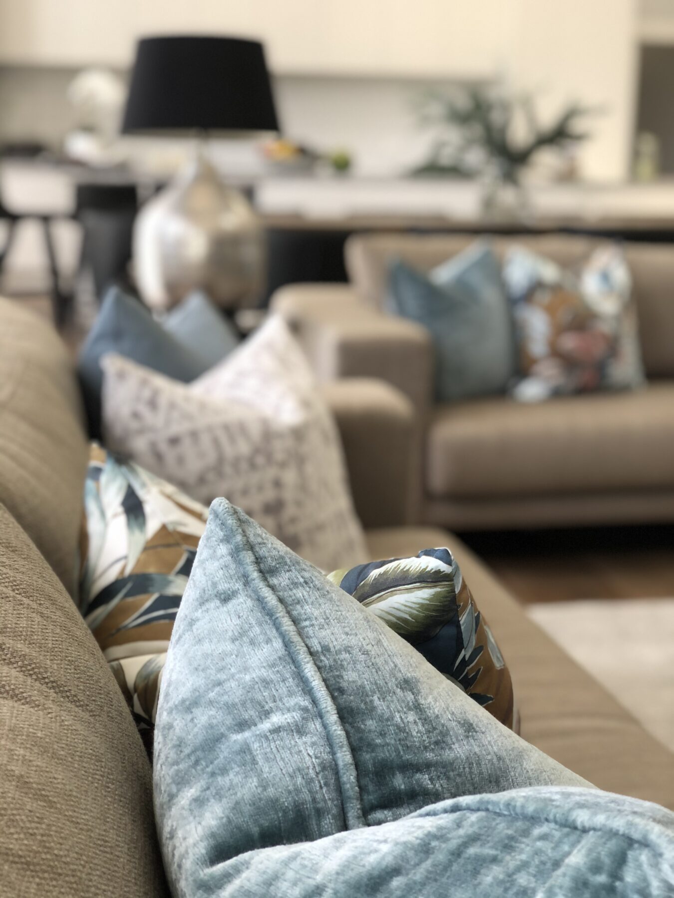 close up of luxurious blue velvet cushion on family lounge sofa