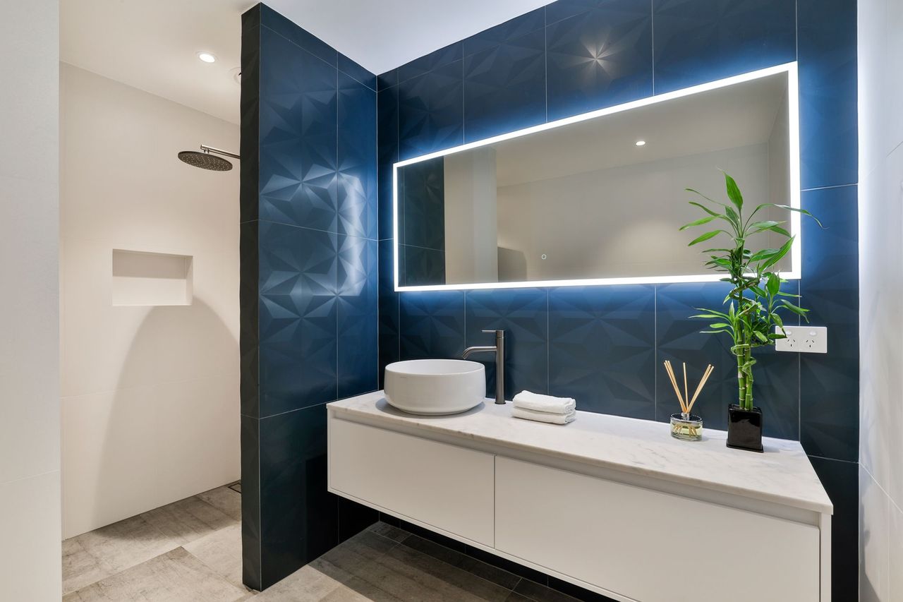 luxury black texture wall bathroom tiles, LED mirror light, simple bathroom styling, wall mounted cabinet