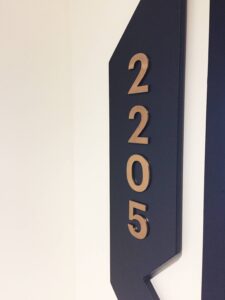 apartment number door sign with brushed brass lewttering