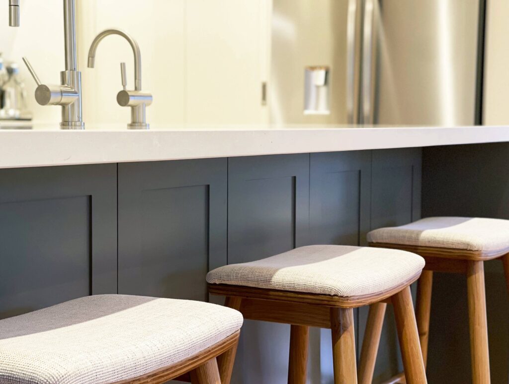 bright and modern contemporary shaker style kitchen with panelling and stone benchtop custom upholstered oak barstools