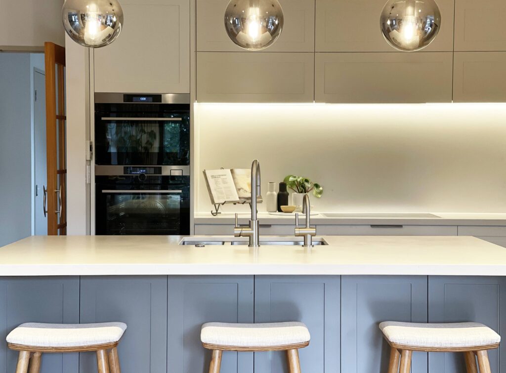 bright and modern contemporary shaker style kitchen with panelling and stone benchtop custom upholstered oak barstools