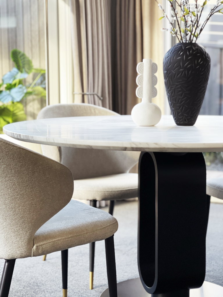 Luxury contemporary dining table and chairs with textured fabric, marble top and brushed brass highlights